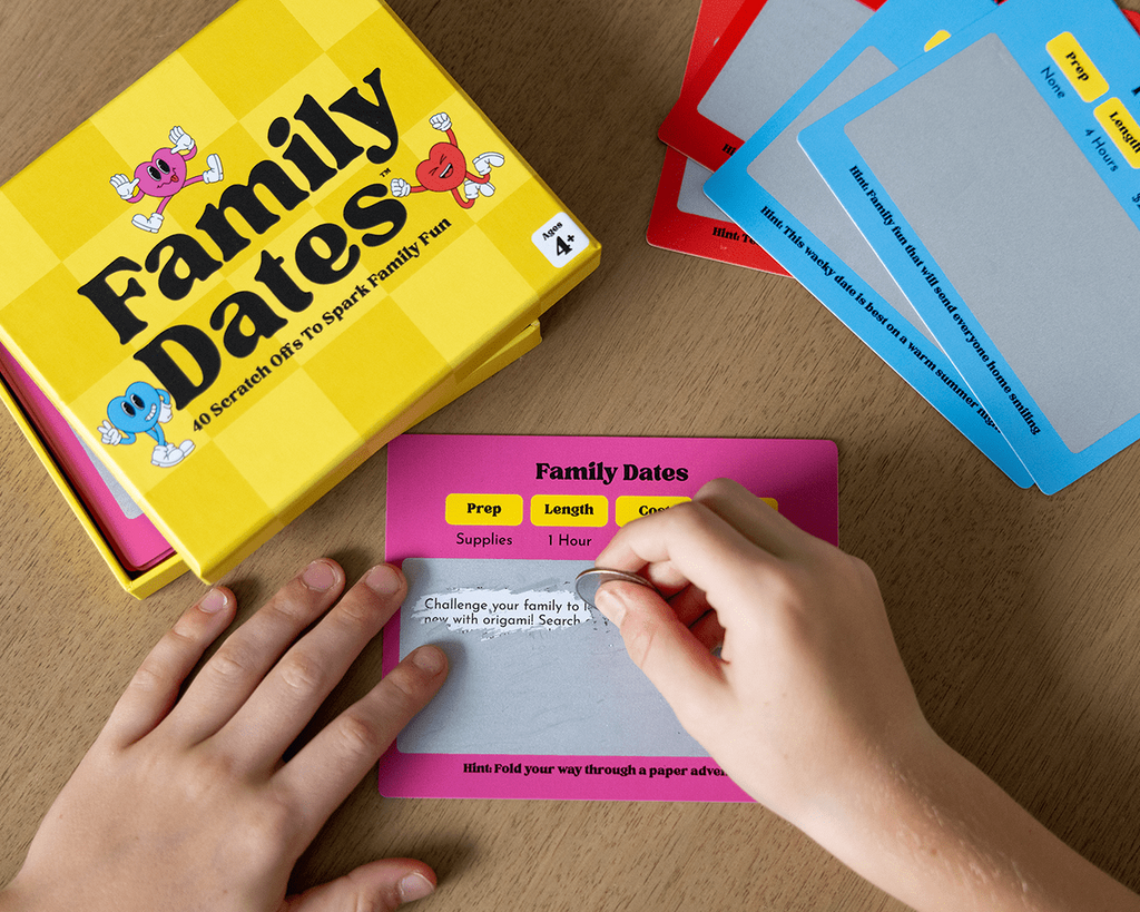 Family Dates game with cards and a box on a wooden surface