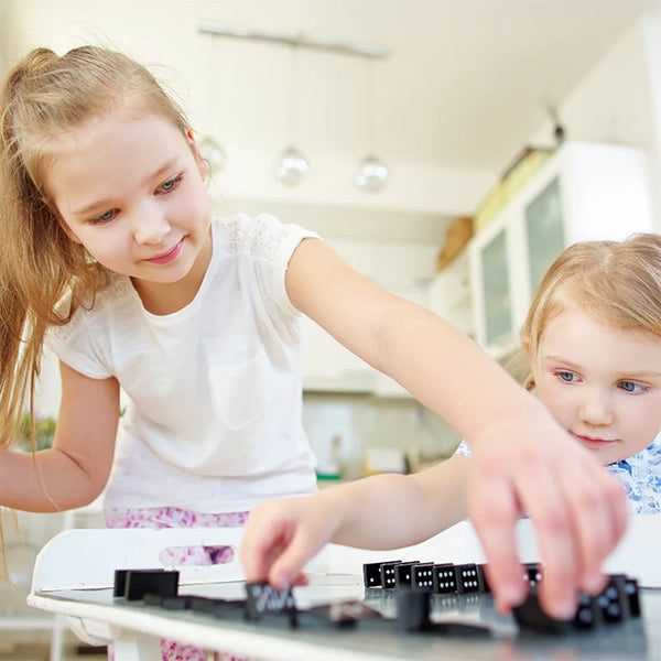 siblings stacking dominoes