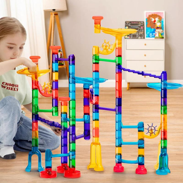 Girl playing with marble run toy