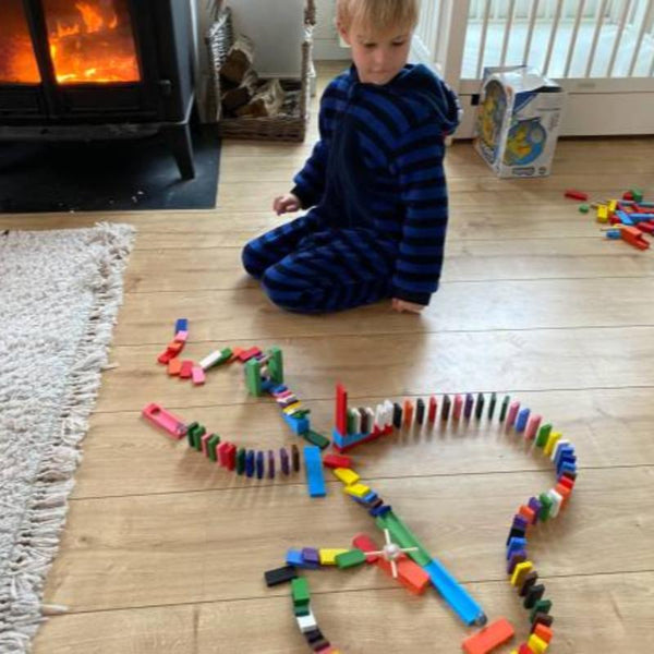 a kid playing with dominoes