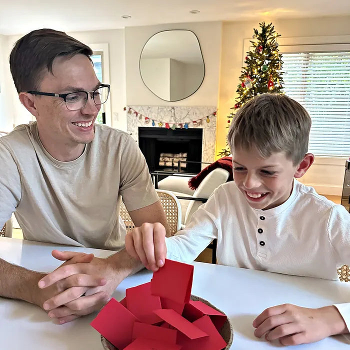 Dad and son laughing during a holiday game