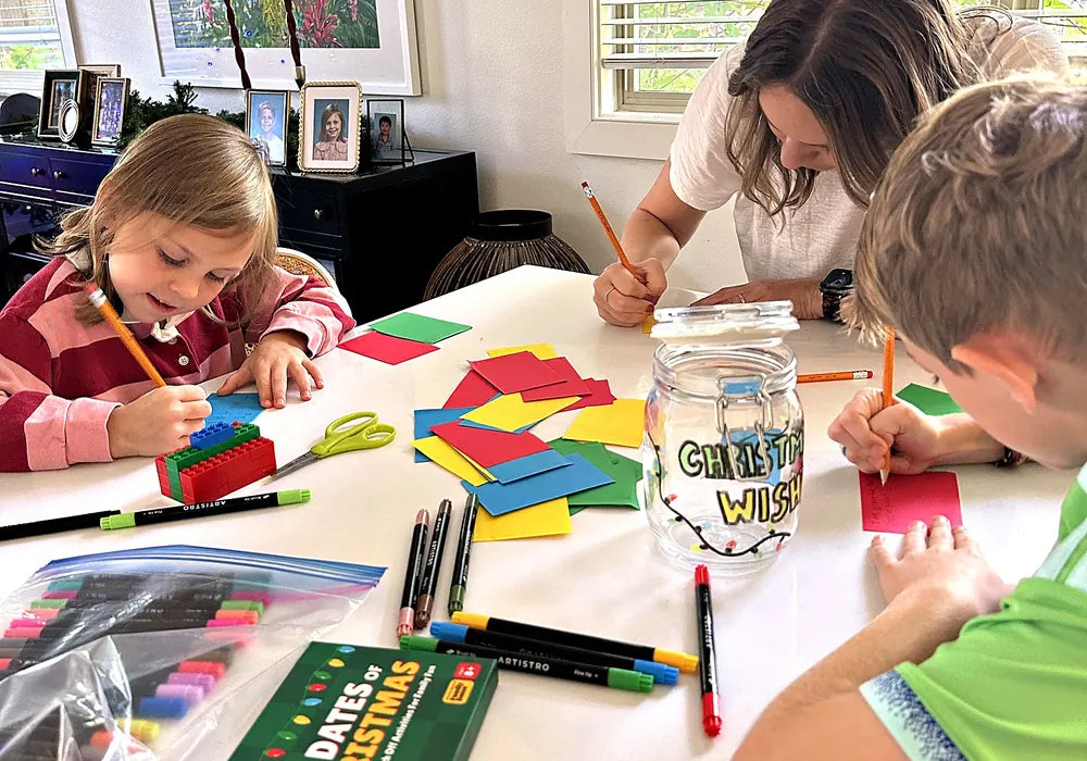 Family writing Christmas wishes together at the table